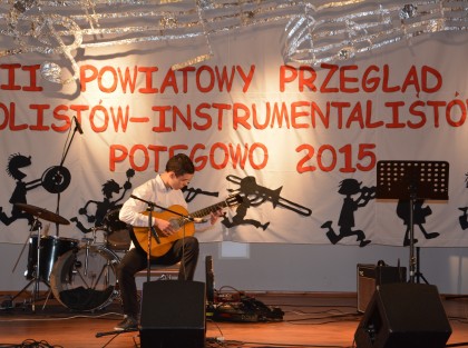 Uczestnik przeglądu grający na gitarze